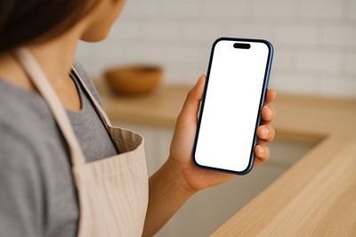 Chef Holding a Blue Phone in the Kitchen