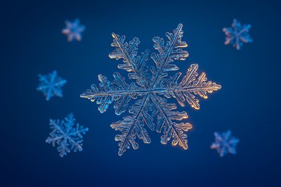 Beautiful Realistic Snowflakes on Blue Background