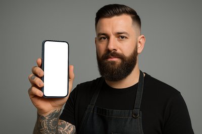 Tattooed Barber Holding a Blue Phone with Blank Screen
