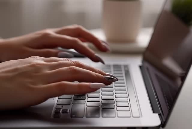 Close-Up of Hands Typing on Laptop Keyboard - Stock Footage
